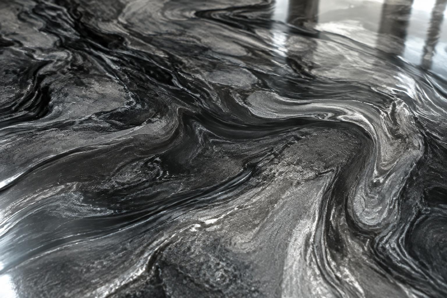 Close view of a charcoal metallic epoxy floor with layered silver movement